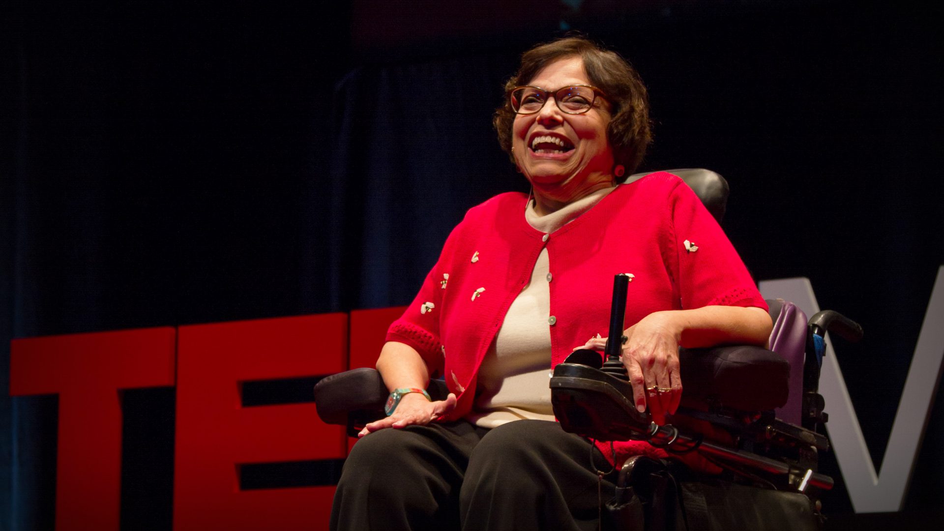 A picture of Judith Heumann speaking on stage at a TED Talk.